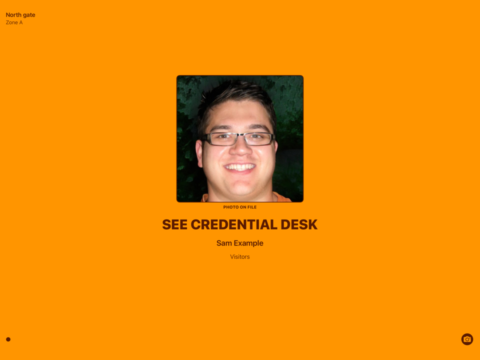 The same screen in orange for someone who needs a second look, asking them to see the credential desk.